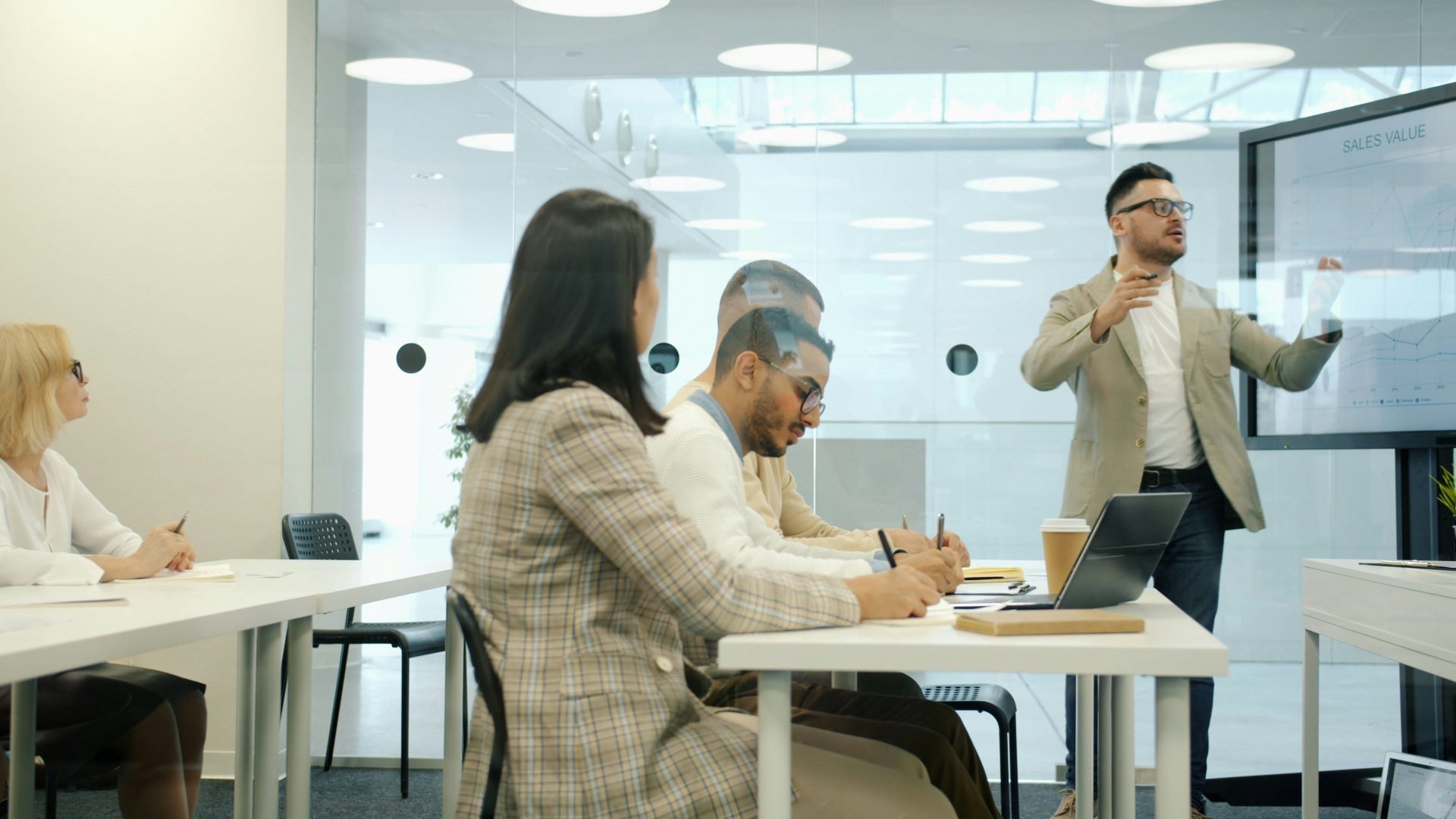 Man presenting to colleagues in a modern office meeting room